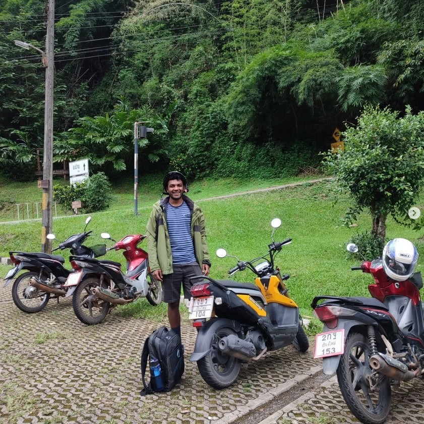 Man standing behind a motorbike